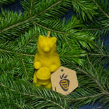 Beeswax candle - Bear with honey in front of fir tree branches